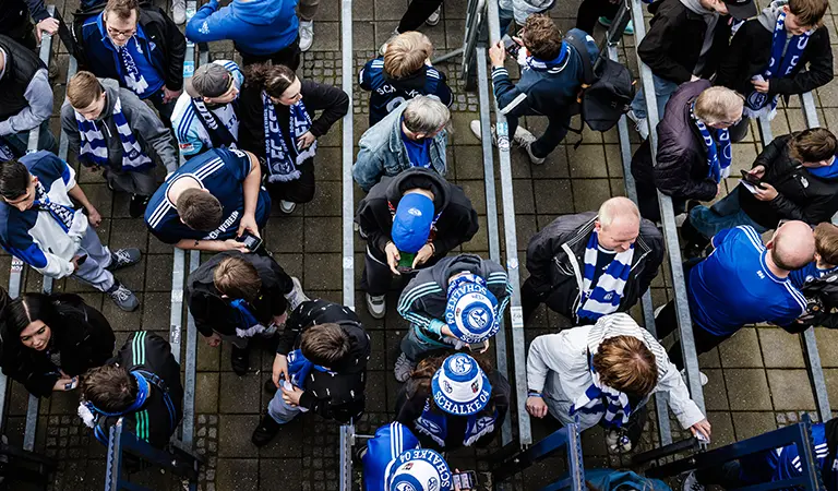 Schalke 04-Fans beim Betreten eines Stadions vor einem Spiel, von oben gesehen. (Foto)
