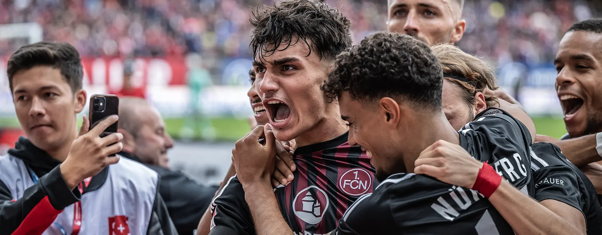 1. FC Nürnberg players celebrating after a goal. (Photo)